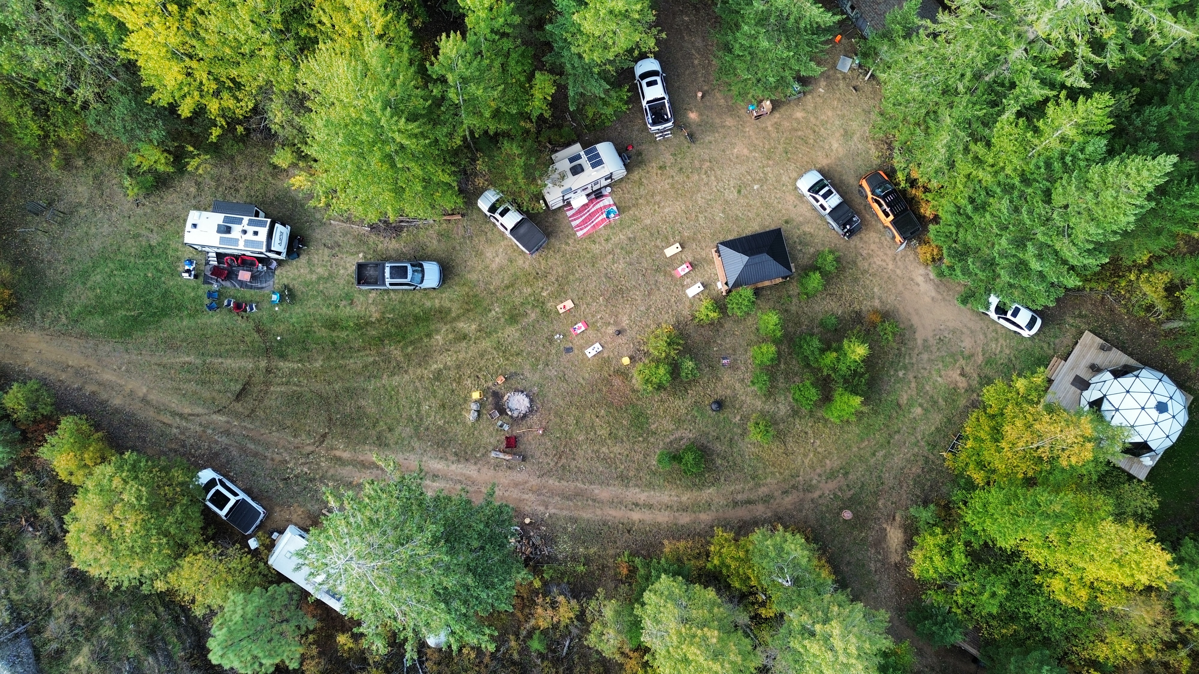 Drone shot straight down at group occupying camping and dome